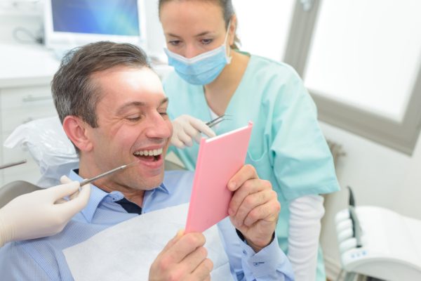 happy patient looking at teeth